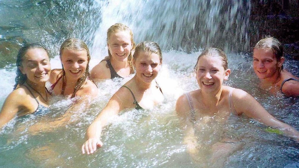 Guests enjoying a splash under a waterfall in Ko Samui 