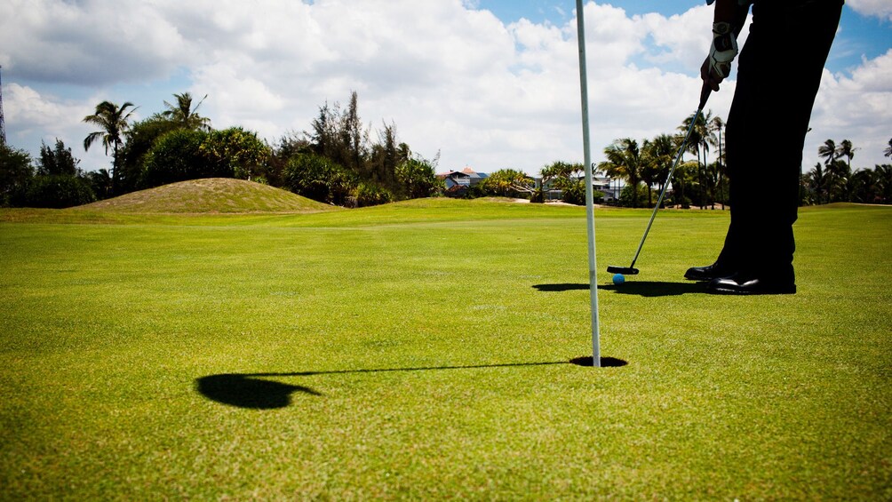 Person golfing on a golf course 