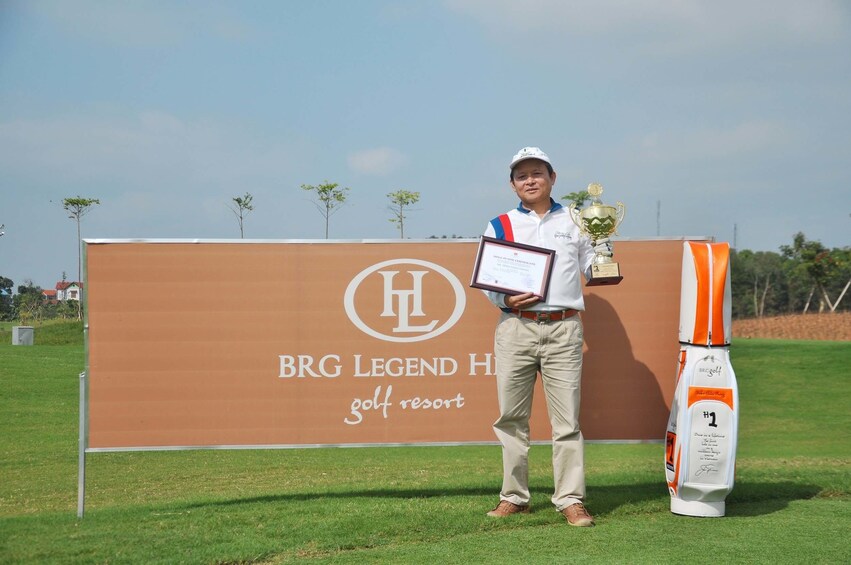 Golfer poses with trophy and certificate at BRG Legend Hills Golf Resort 1