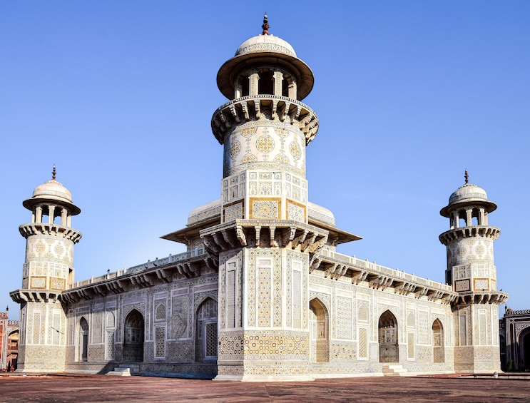 A large, intricately designed building with multiple domes and minarets, featuring detailed tile work and arches. 5