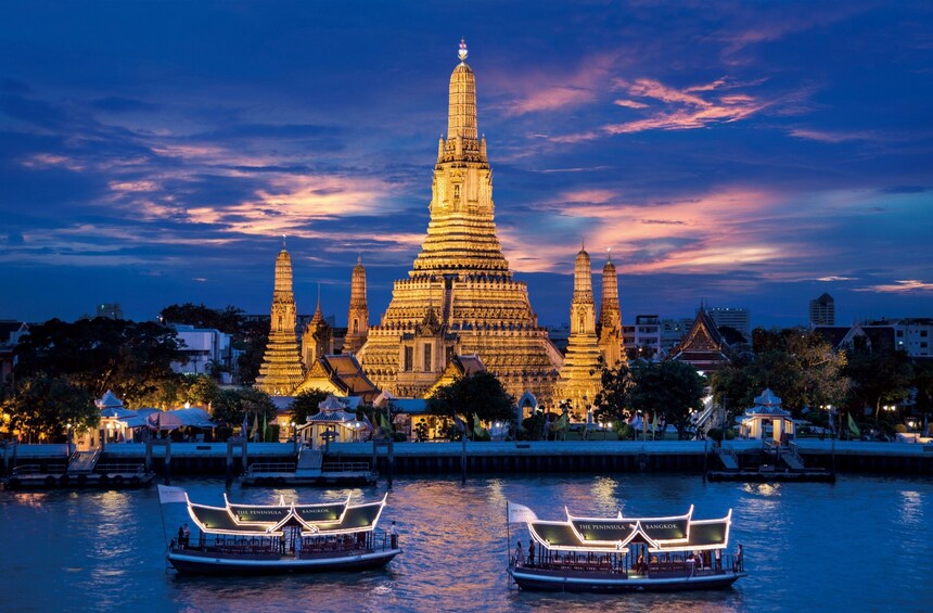 Wat Arun Temple and Chao Phraya River lit up at night