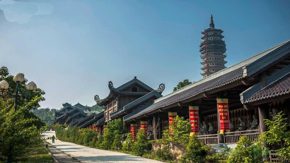 Traditional East Asian architecture with pagoda-style towers and ornate buildings along a pathway. 5
