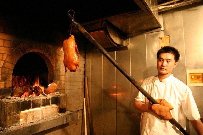 Chefs in the kitchen bring dishes to life with fresh ingredients—a scene guests love on our Chinatown Food Tours. Food Tours in Chinatown highlight this authentic culinary craft up close. 2