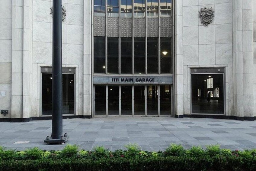 A building with a sign reading '1111 MAIN GARAGE' and a large entrance. 1