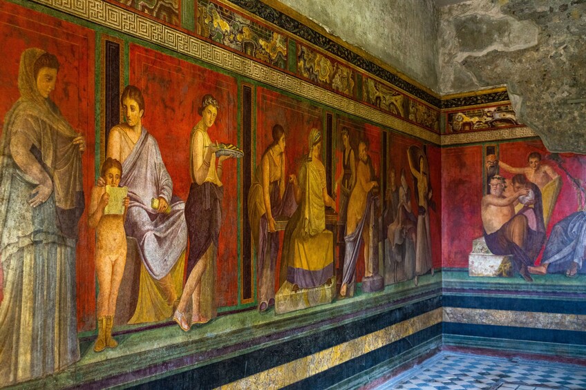 A fresco mural with classical figures in a historical setting. 4