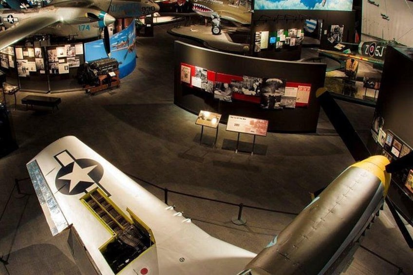A museum exhibit with aircraft and informational displays. 4