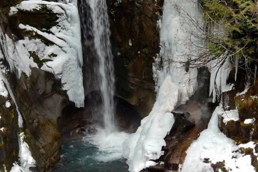A waterfall surrounded by snow and ice formations. 3