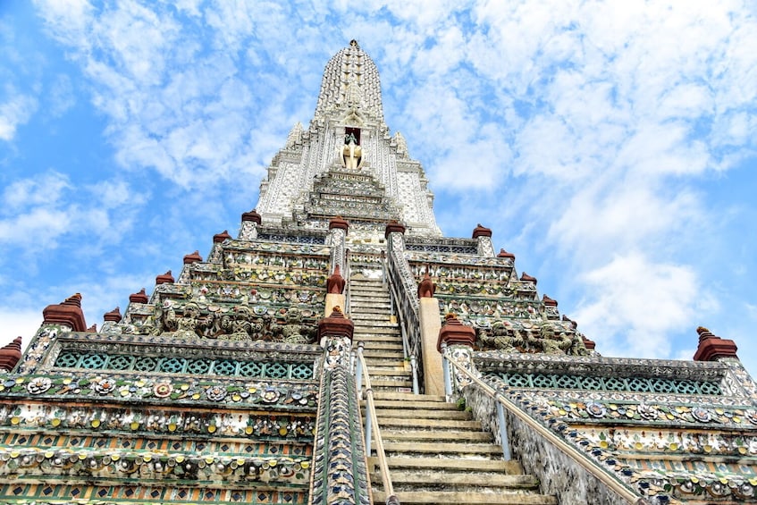 A temple with intricate designs and a large staircase leading to the top. 5