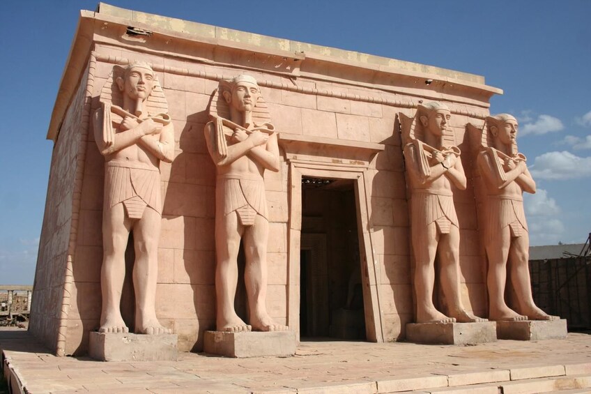 Una struttura in pietra con quattro grandi statue raffiguranti figure dell'antico Egitto. 4