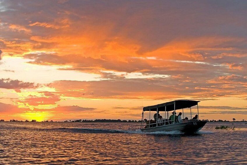 Un bote en el agua durante el atardecer con un cielo colorido. 5