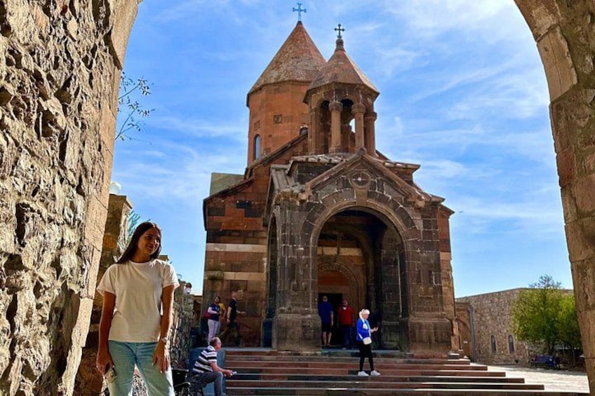 A stone church with a bell tower and arched entrance. 2