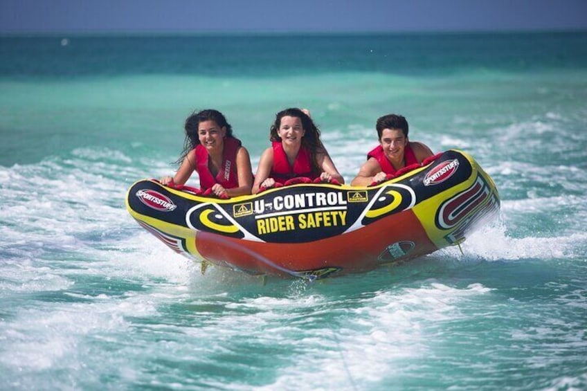 Three people on a watercraft with 'U-Control Rider Safety' and 'Sportslife' logos. 4