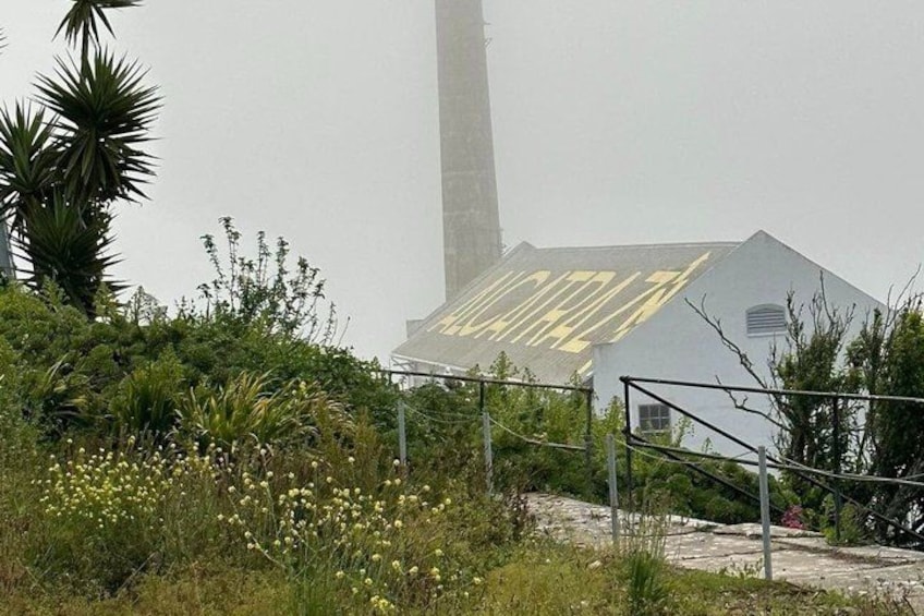 A building with a sign that reads 'MORALITA' and a tall structure in the background. 3
