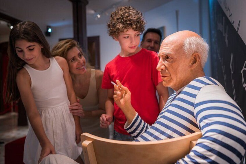 A group of people in a room with a person seated in a chair. 5