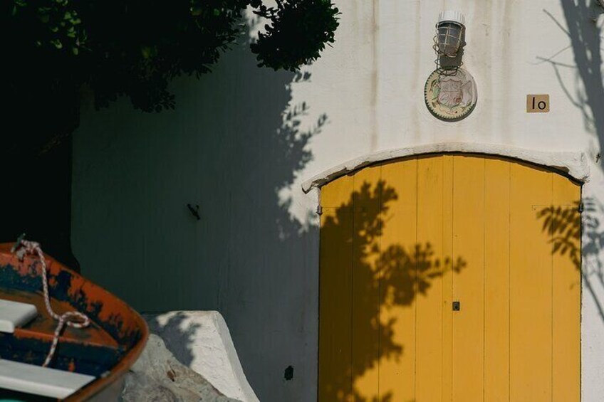 A yellow door with a number plate '10' and a wall-mounted light fixture. 3