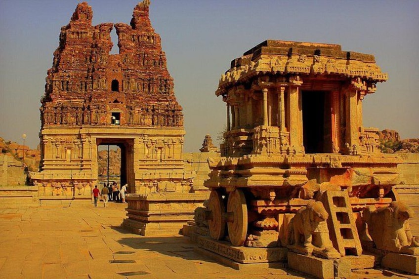 Ancient temple ruins with intricate carvings and a stone chariot. 5