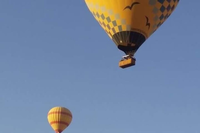 Two hot air balloons against a clear sky. 5