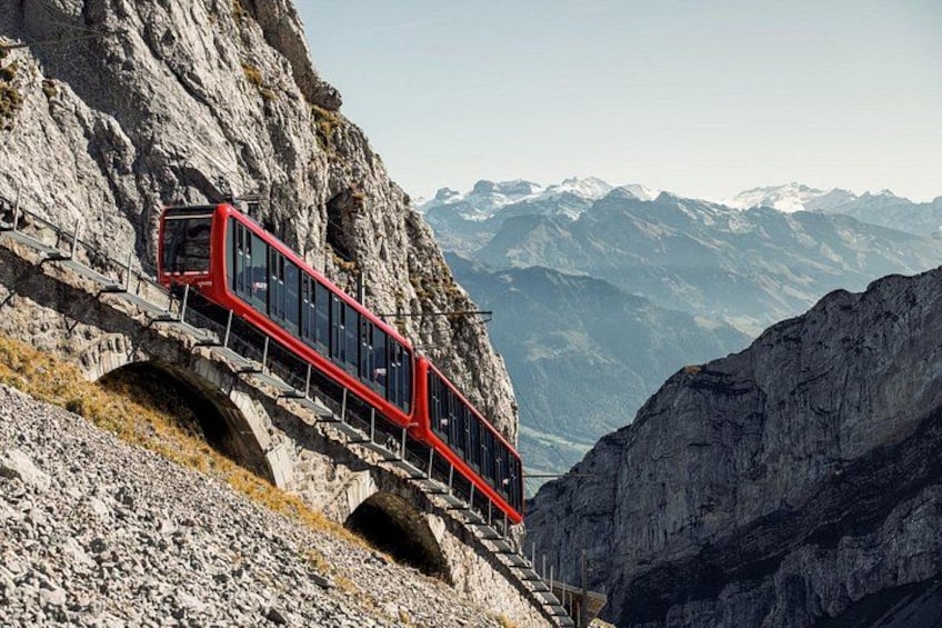 A red cable car on a mountain track. 4