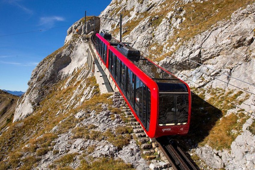 A red train on a mountainous track. 3