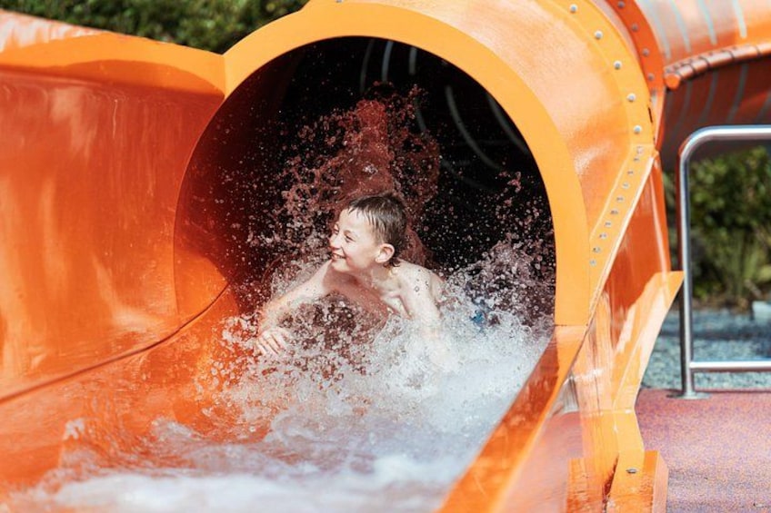 A child sliding down a water slide. 2