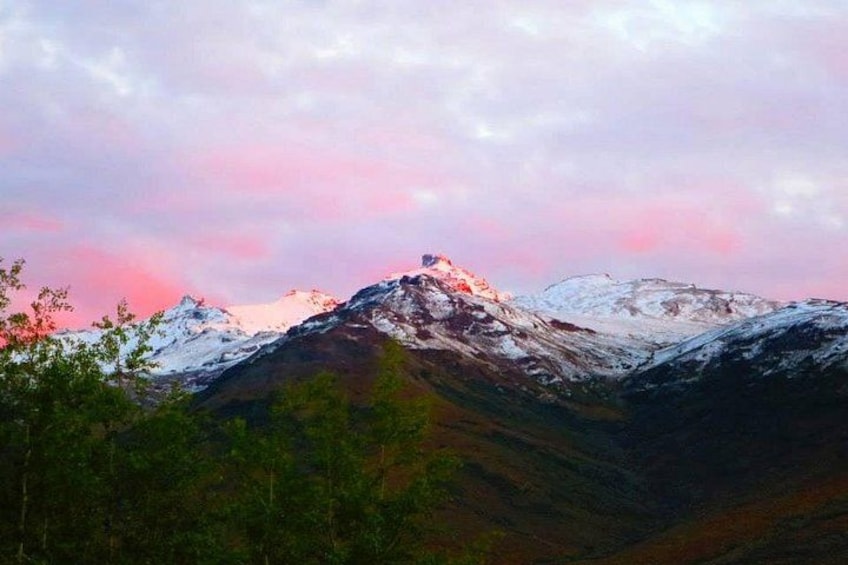 Cordillera con picos nevados y un cielo rosado. 3