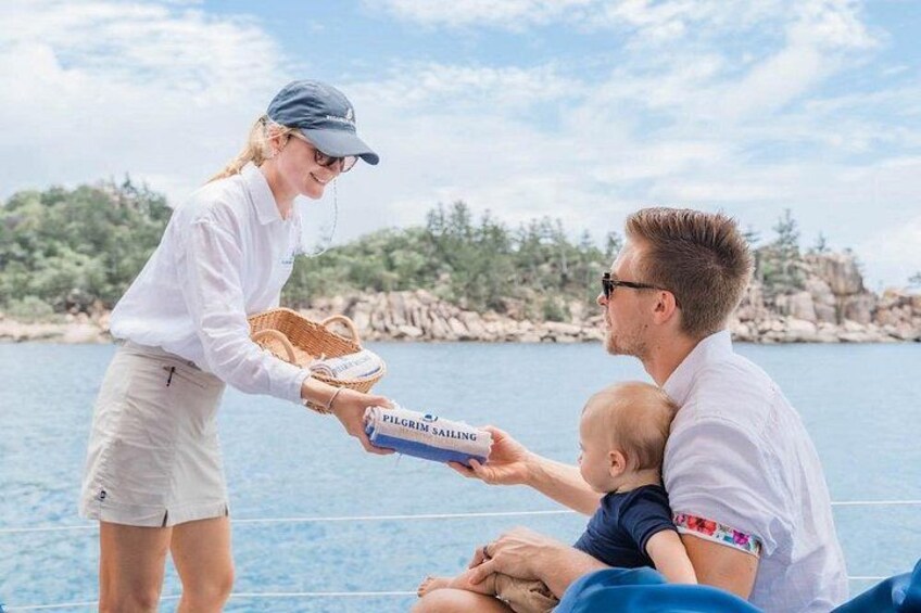 A person handing a box labeled 'PILGRIM SAILING' to a seated individual. 4