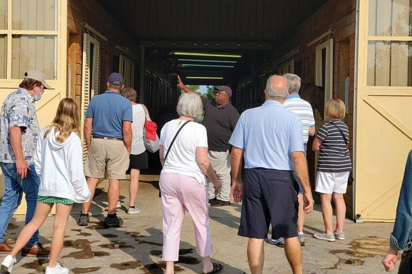A group of people walking through a covered walkway. 2