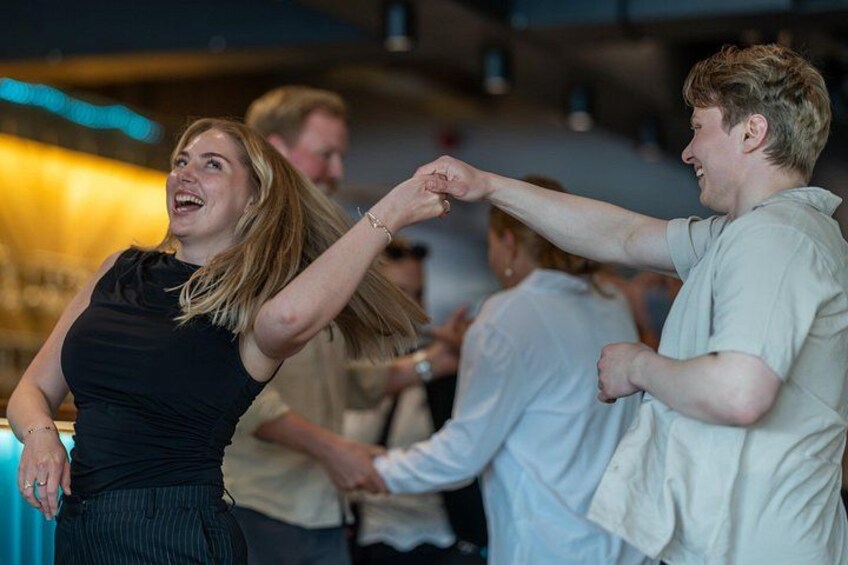 People dancing at an indoor event. 3