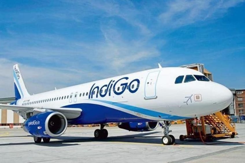 An IndiGo airplane parked at an airport. 2