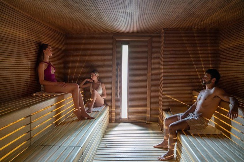 A sauna with wooden benches and a large window. 3