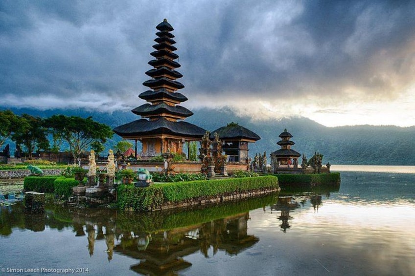 A serene lake with traditional pagodas and a reflection of the structures. 5