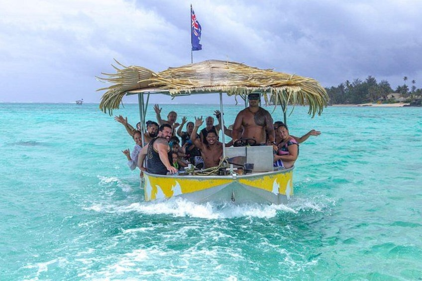 A boat with passengers, a thatched roof, and a flag. 2