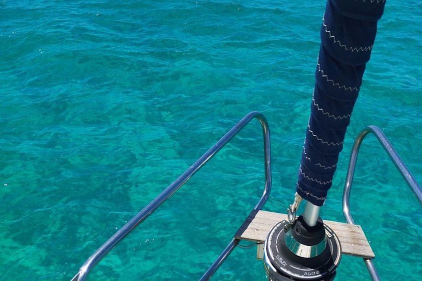 A metal ladder leading into clear turquoise water. 3