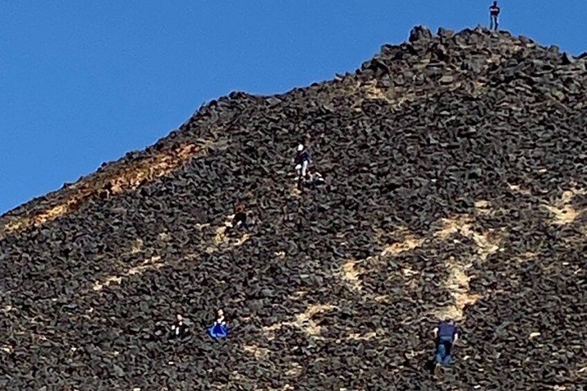 A rocky mountain with people climbing. 3