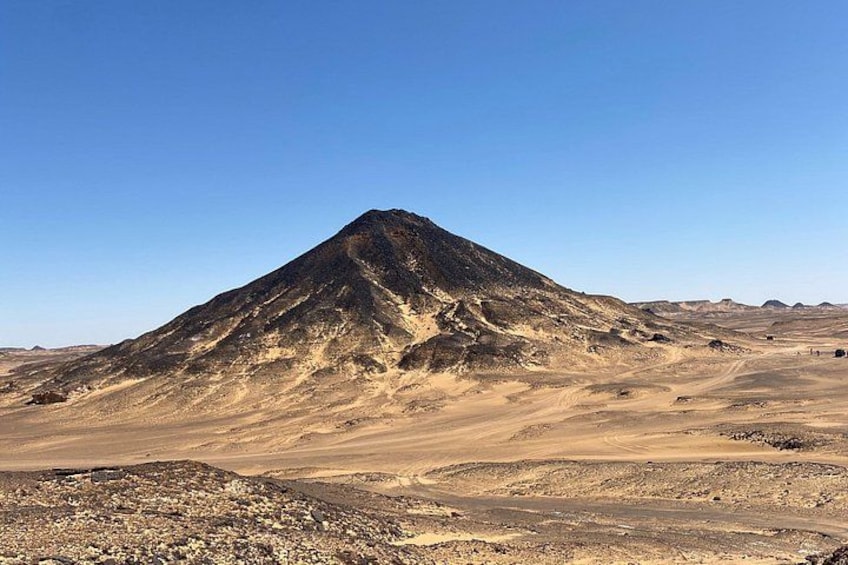A desert landscape with a prominent mountain. 2