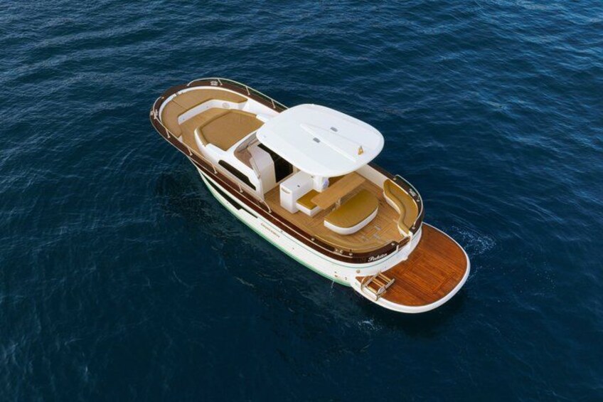 A boat with a cabin, seating area, and a covered deck. 2