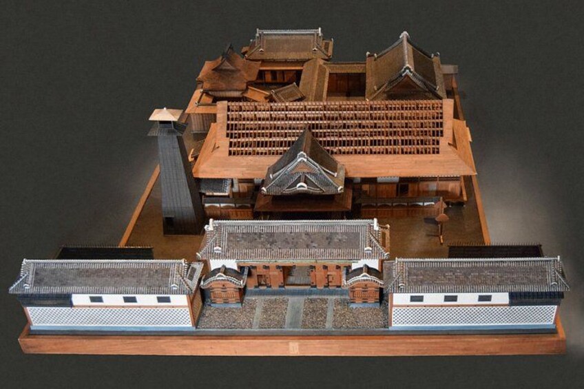 A detailed model of a traditional Japanese castle with multiple buildings and a moat. 3