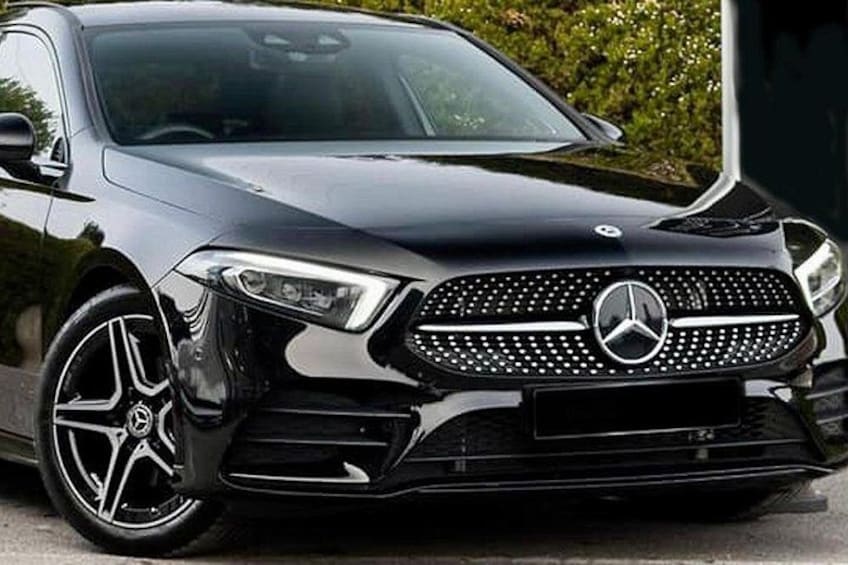 A black Mercedes-Benz SUV with a distinctive grille and alloy wheels. 4