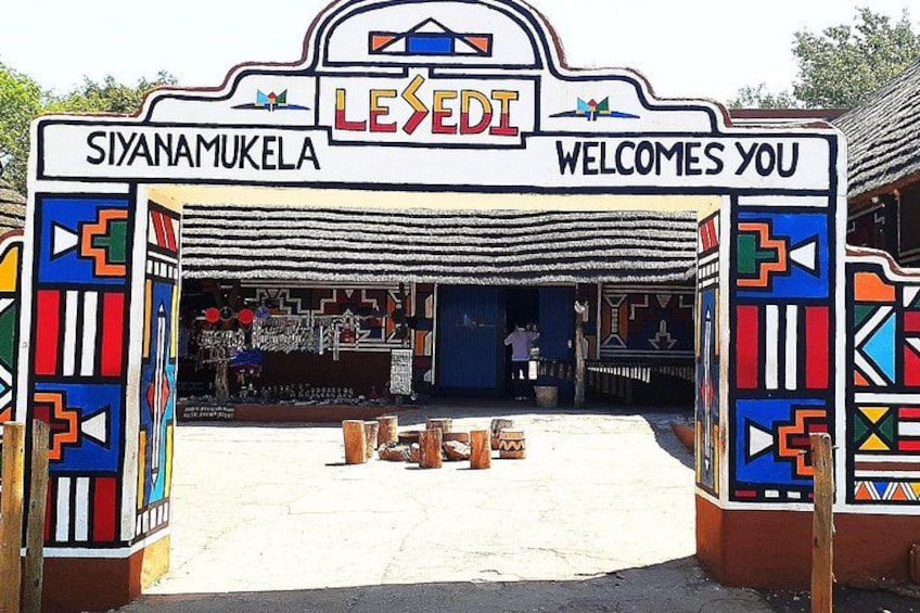 A colorful entrance with a sign reading 'Siyananukela' and 'Welcome you'. 3