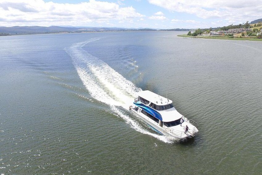 A boat speeding across a large body of water with a wake behind it. 3