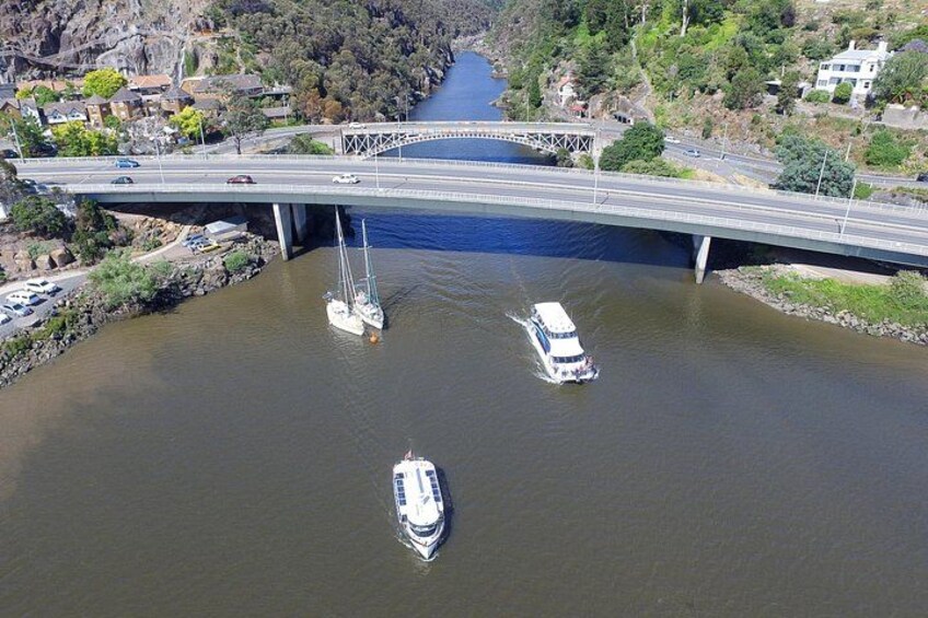 A bridge over a river with boats. 5