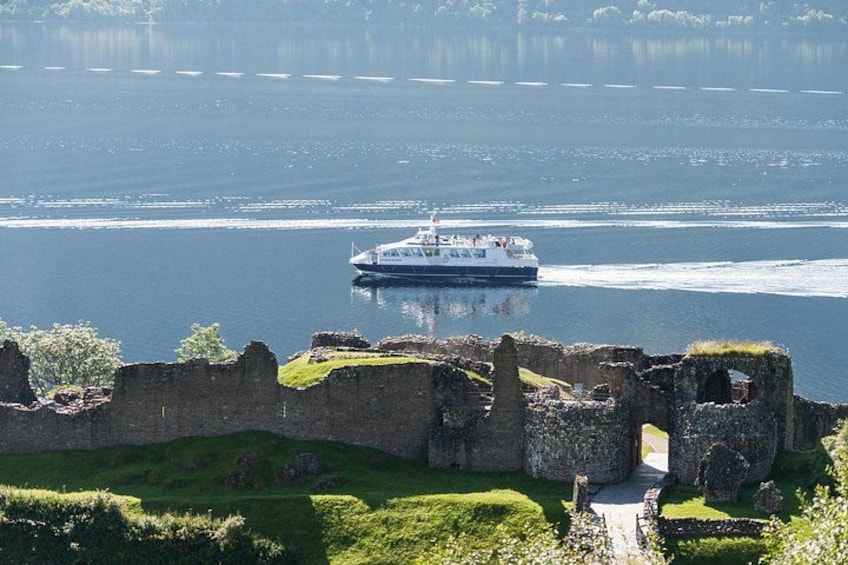 A boat on a calm river, surrounded by ruins of a historical structure. 2