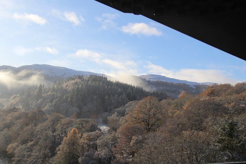 A mountainous landscape with dense forests and a clear sky. 4
