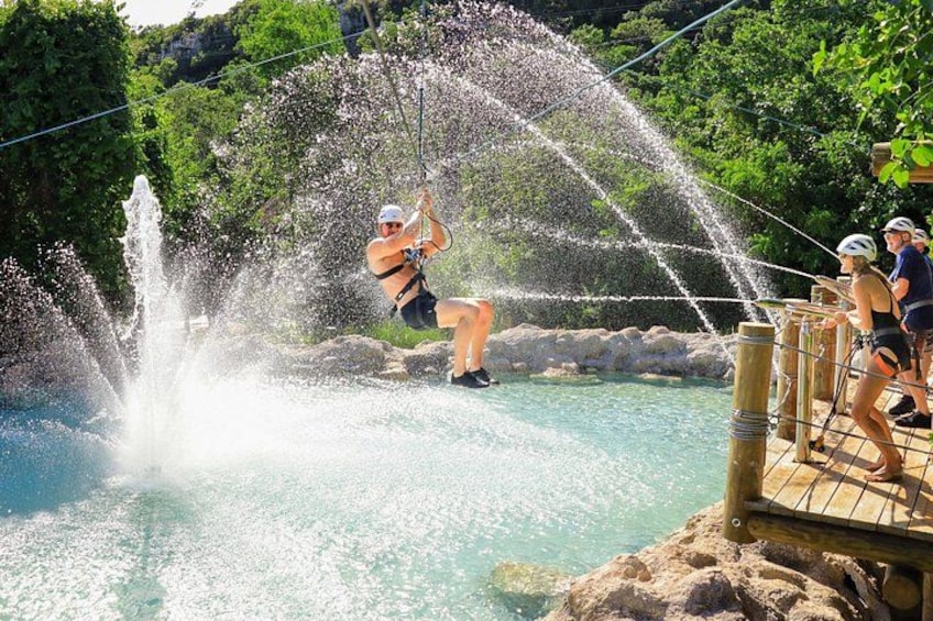 A person water skiing on a body of water with a water fountain feature. 3