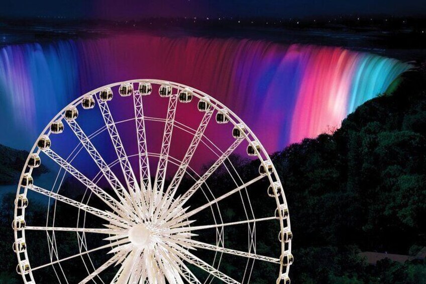 A large Ferris wheel with a colorful waterfall in the background. 4