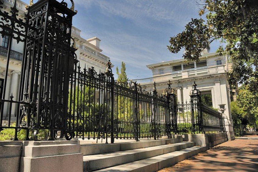 A wrought iron fence with steps leading to a building. 2