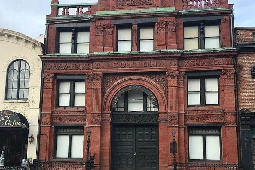 A red brick building with ornate detailing and the name 'Savannah Cotton Exchange' on the facade. 3
