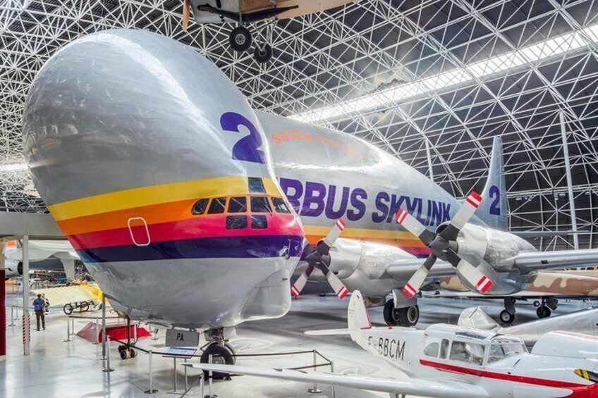 Two Airbus A380 aircraft with colorful livery inside a hangar. 2