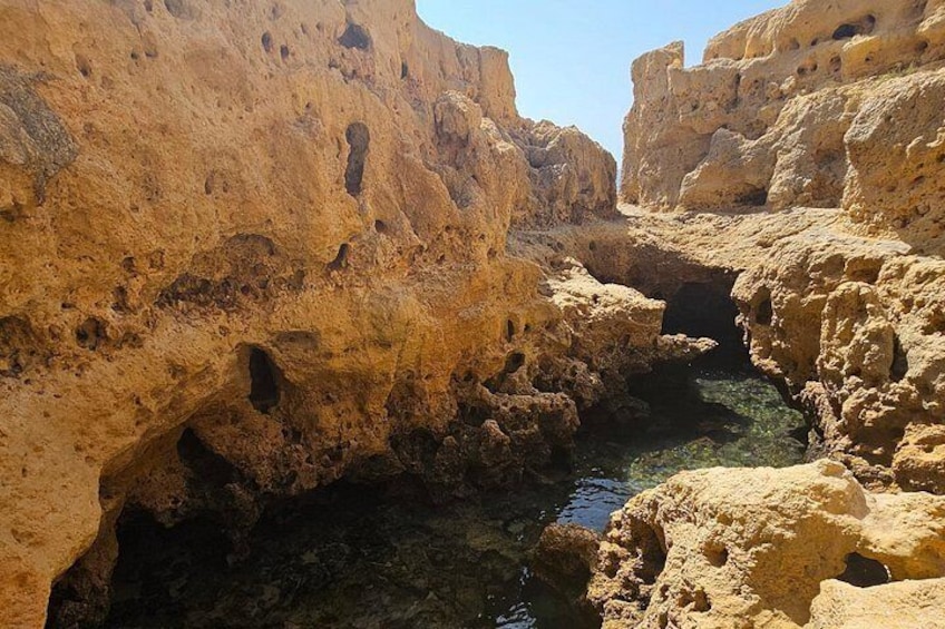 A rocky canyon with a narrow water channel. 2