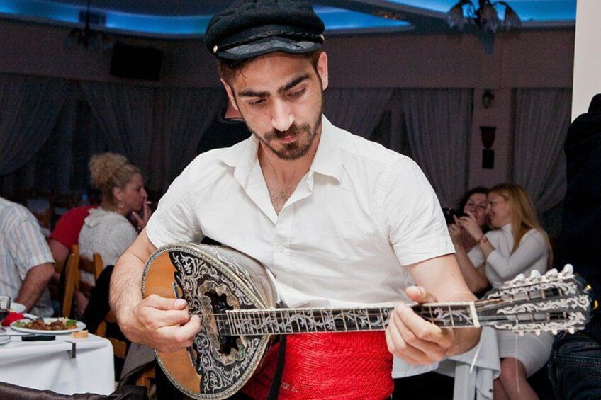 A person playing a banjo at a social event. 3